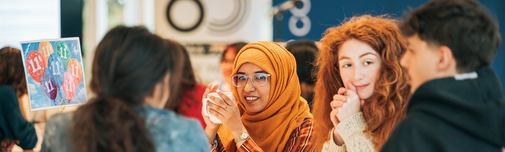 A table of young people discuss their findings at an event celebrating the University of Bath's 60th anniversary.