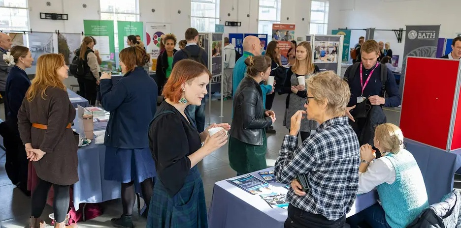 Attendees speak with exhibitors of the Festival of Social Science.