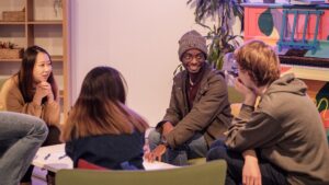 A group of students sit in a circle talking