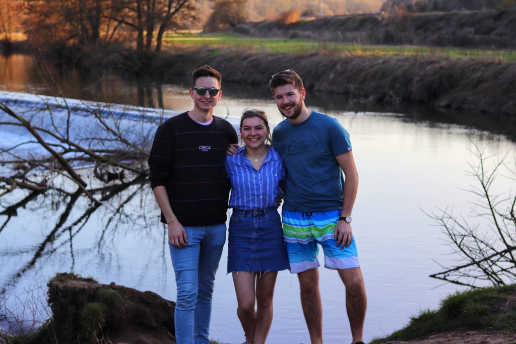 Me with two friends (male and female) stood in front of a lake