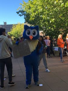 A student dressed up in an owl outfit on the Parade amongst other students during Welcome Week at Bath