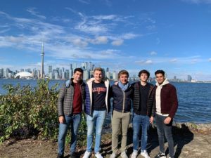 Five students standing in front of the Toronto skyline