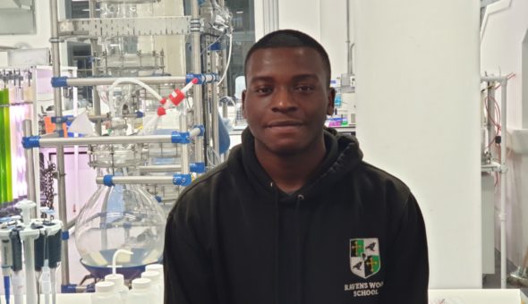 Me wearinga black hoody with a school crest stood in front of the chemical engineering department's laboratory