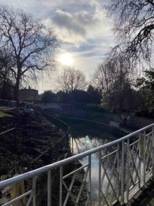 Bridge over a canal, with trees on the side.