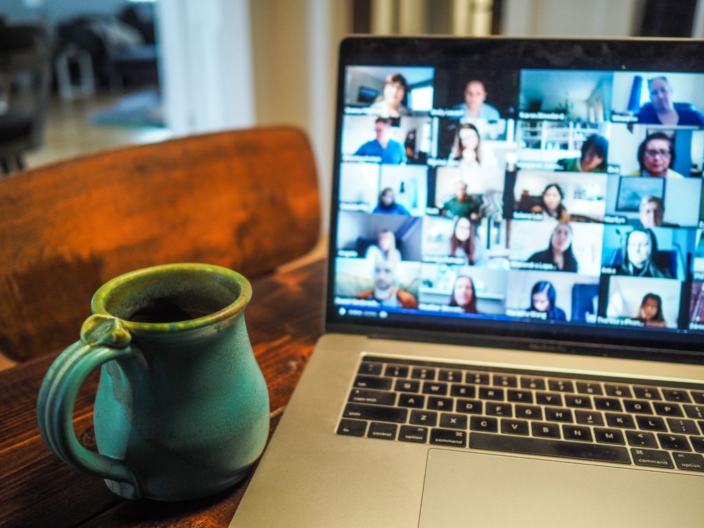 Mug and computer screen with lots of zoom callers