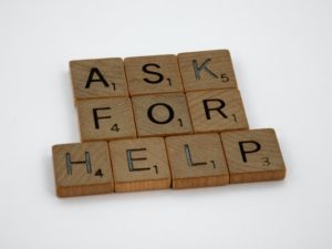 Scrabble letters stating "ask for help".