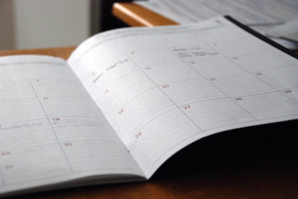 A large, double-page spread calendar open on a table