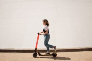 Woman riding electric scooter