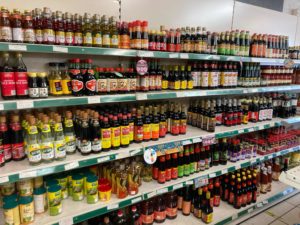 Rows of colourful bottles containing Eastern sauces and condiments.