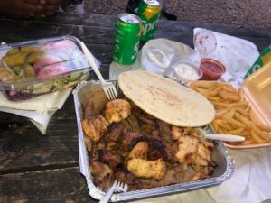 A picture of a mixed grill meal with a side of salad and fries.