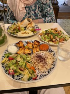 Two Lebanese meals (Chicken cubes with rice, and a lamb wrap), with a side meal of salad.