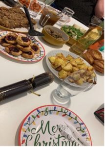 A table with our Christmas dinner, drinks, and Christmas crackers