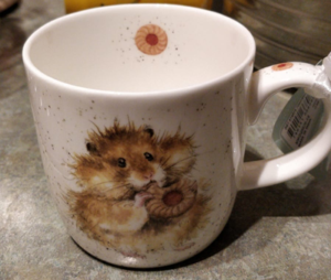 A mug with a cute hamster on it