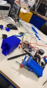 Prototyping equipment such as wires, breadboards and 3D printed parts on a table.