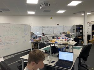 A studio space with multiple tables, whiteboards, laptops and prototyping equipment.