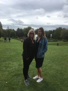 Stacey and a fellow student stood on campus in the green open space