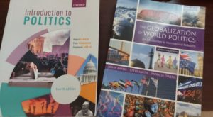 Two colourful Politics textbooks displayed on a table. One on the left titled 'Introduction to Politics' and one on the right titled 'The Globalisation of World Politics'