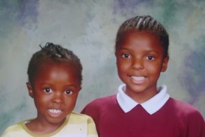 Me and younger sister posing for primary school photo