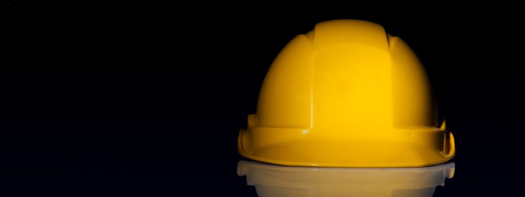 yellow hard hat on a black background