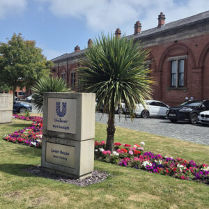 An office building with a sign outside that reads: Unilever - Port Sunlight.