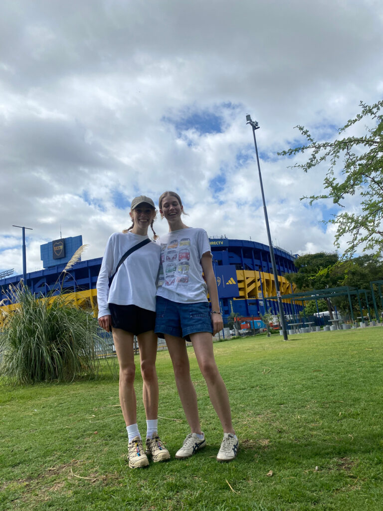 Two people (Nell and Immie) posing in front of Boca Juniors football Stadium