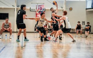 A group of men playing basketball in an indoor court