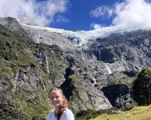Grace in front of a vast mountainous landscape