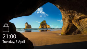 Screenshot of a Windows screensaver, showing a picture of a sandy beach from under a natural rock archway