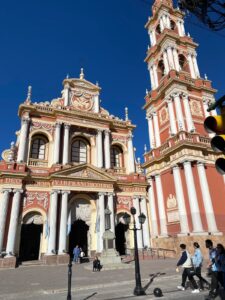 A white and orange building and tower in Salta, Argentina 