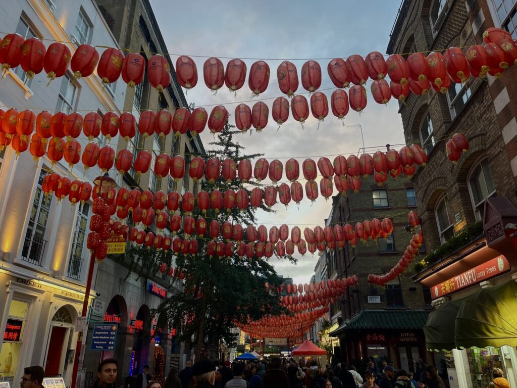 Street in Chinatown, London, with red Chinese Lanterns hanging between buildings.