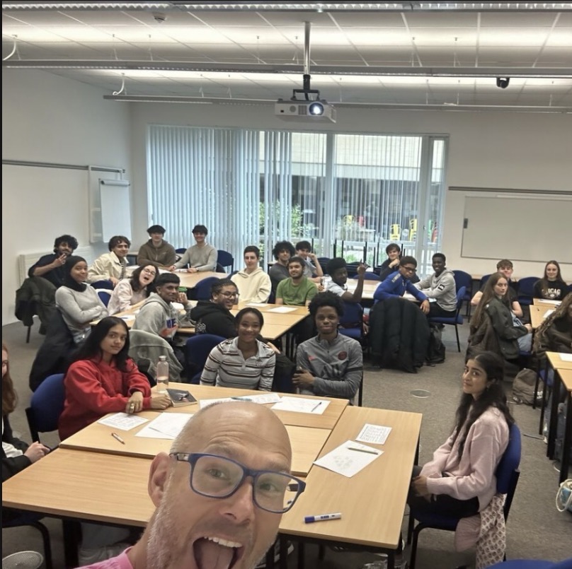 The man taking the selfie is martin a speaker who spoke about wellbeing,confidence and engaging us in a wide range of activities. This image captures a lively classroom moment during summer school showing participation and group engagement.