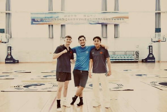 A picture of me, a summer school volunteer, and a summer school student after a martial arts class