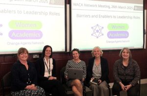 Picture shows 5 women seated in front of projection screens